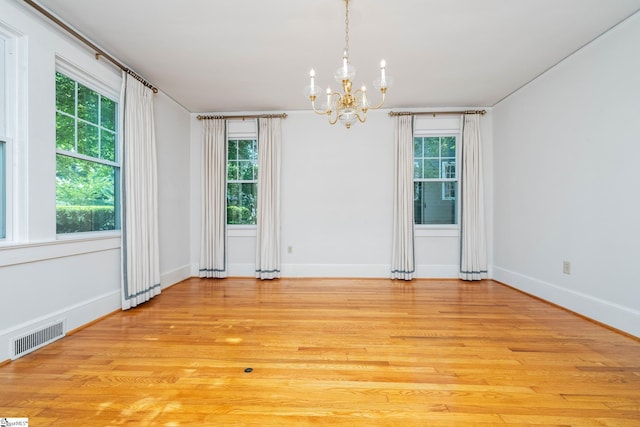 306 Mcdaniel Ave, Greenville, SC 29601 - empty room with a chandelier and light wood finished floors