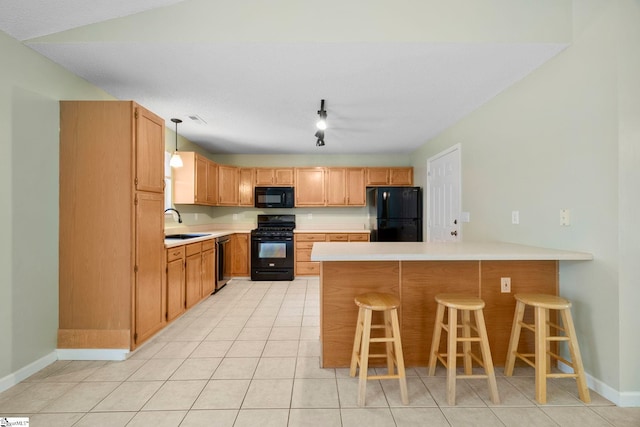 210 Admiral Ln, Greer, SC 29650 - kitchen featuring black appliances, a peninsula, light countertops, and a kitchen breakfast bar
