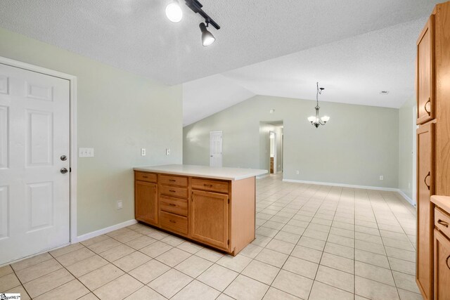 210 Admiral Ln, Greer, SC 29650 - kitchen with a peninsula, light countertops, a chandelier, light tile patterned floors, and lofted ceiling