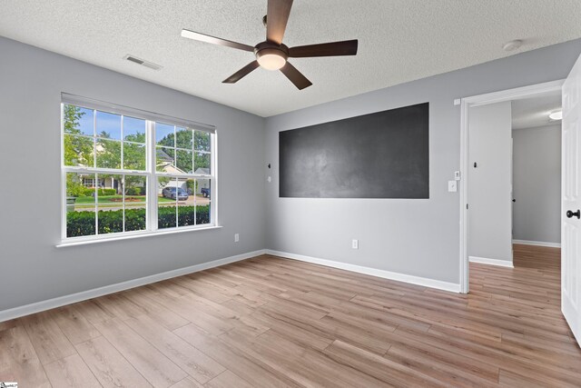 29 Parkgate Ct, Simpsonville, SC 29680 - empty room with ceiling fan, a textured ceiling, light wood-type flooring, and a smoke detector