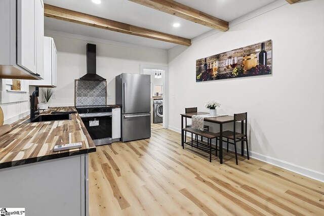 119 Trussell St, Honea Path, SC 29654 - kitchen with freestanding refrigerator, wall chimney range hood, washer / clothes dryer, electric stove, and wooden counters
