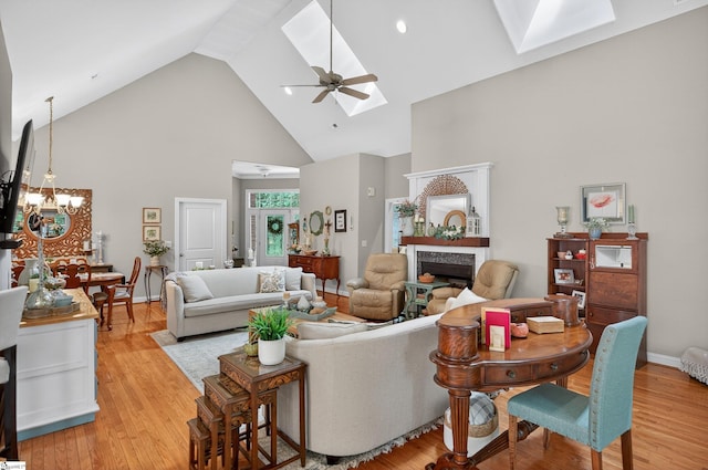 109 Tall Ship Dr, Anderson, SC 29625 - living area featuring a skylight, high vaulted ceiling, a fireplace, a chandelier, and light wood-style floors