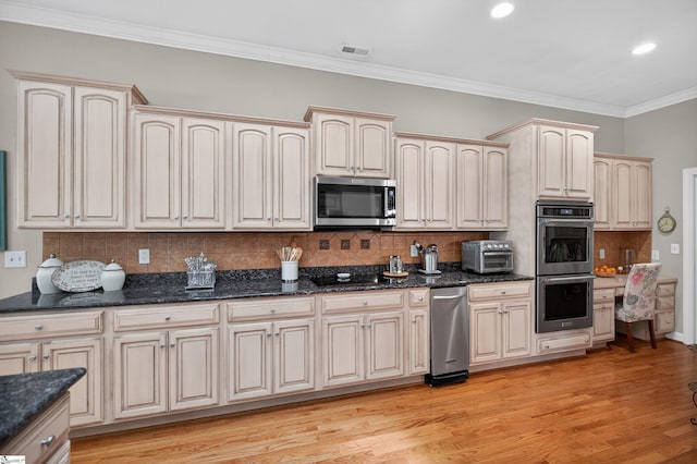 109 Tall Ship Dr, Anderson, SC 29625 - kitchen with stainless steel appliances, ornamental molding, tasteful backsplash, light wood-style floors, and dark stone counters