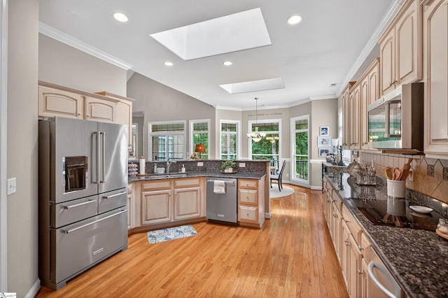 109 Tall Ship Dr, Anderson, SC 29625 - kitchen featuring stainless steel appliances, a skylight, a peninsula, light wood-style floors, and crown molding