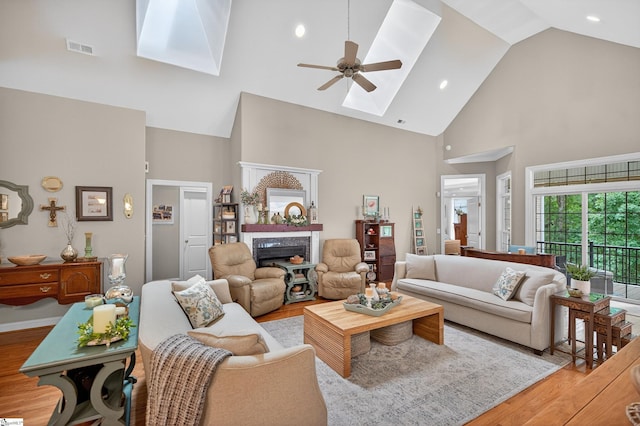 109 Tall Ship Dr, Anderson, SC 29625 - living room with a skylight, high vaulted ceiling, ceiling fan, a fireplace, and light wood finished floors