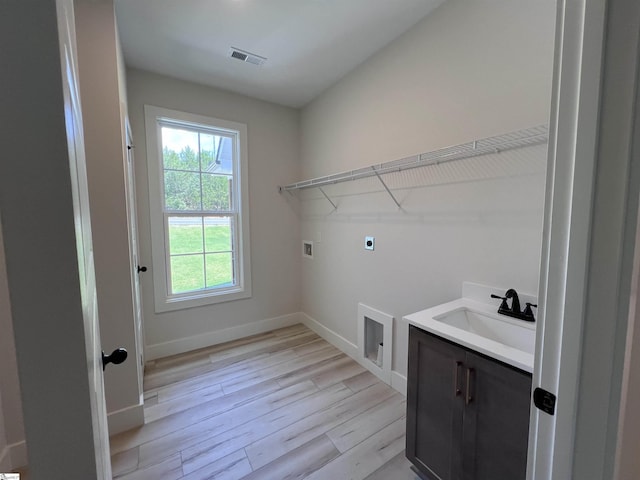 3352 Earls Bridge Rd, Easley, SC 29640 - washroom with electric dryer hookup, washer hookup, light wood finished floors, and cabinet space