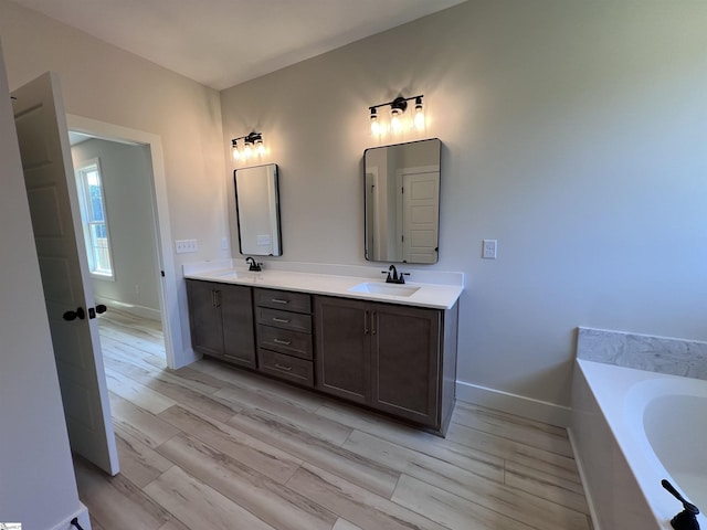 3352 Earls Bridge Rd, Easley, SC 29640 - bathroom featuring double vanity, a garden tub, and wood finished floors