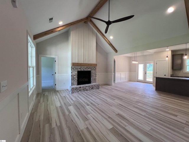 3352 Earls Bridge Rd, Easley, SC 29640 - unfurnished living room with a decorative wall, wainscoting, ceiling fan, light wood finished floors, and a brick fireplace