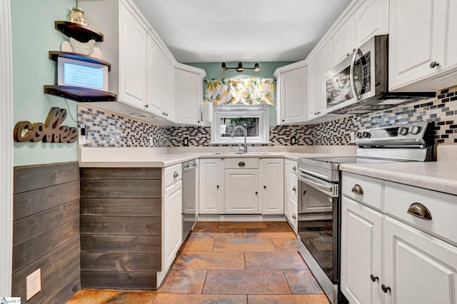 226 Mariposa Cir, Anderson, SC 29621 - kitchen featuring appliances with stainless steel finishes, backsplash, white cabinetry, stone finish flooring, and light countertops