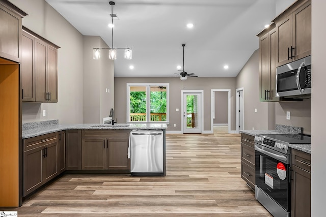 156 Grand Oak Cir, Pendleton, SC 29670 - kitchen with stainless steel appliances, a peninsula, light wood finished floors, a ceiling fan, and light stone countertops