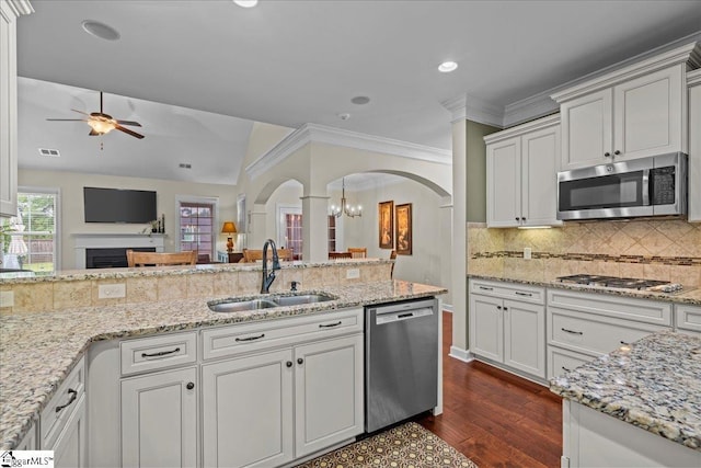 228 Holstein Ct, Fountain Inn, SC 29644 - kitchen featuring appliances with stainless steel finishes, arched walkways, ceiling fan, dark wood-style floors, and backsplash