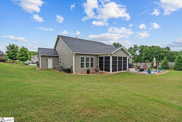 228 Holstein Ct, Fountain Inn, SC 29644 - back of house with a sunroom, a patio area, a lawn, and roof with shingles