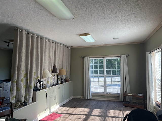 101 Elm St, Clinton, SC 29325 - sitting room featuring a textured ceiling, ornamental molding, healthy amount of natural light, and wood finished floors