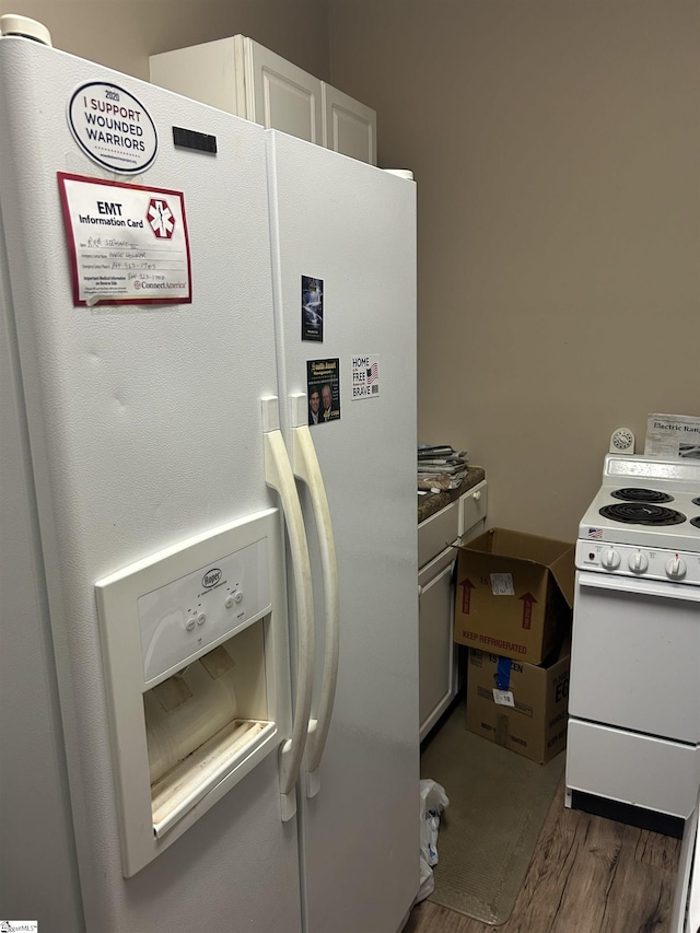 101 Elm St, Clinton, SC 29325 - kitchen with white appliances, wood finished floors, and white cabinetry
