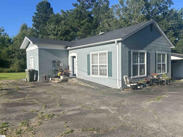 101 Elm St, Clinton, SC 29325 - view of side of home featuring concrete block siding and roof with shingles