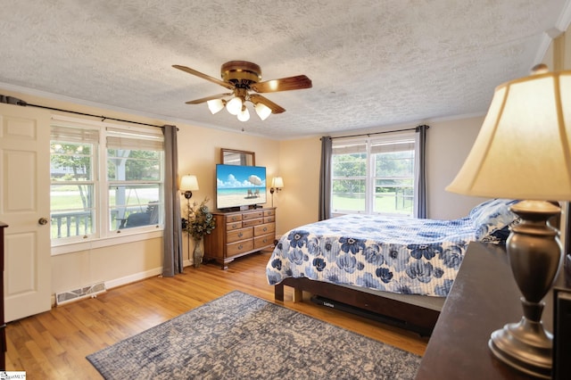 506 Piedmont Hwy, Piedmont, SC 29673 - bedroom with wood finished floors, crown molding, a textured ceiling, and a ceiling fan