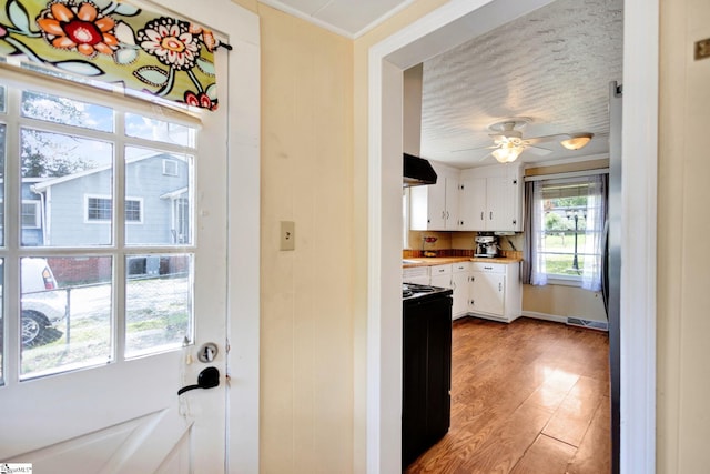 506 Piedmont Hwy, Piedmont, SC 29673 - kitchen featuring ventilation hood, electric stove, white cabinetry, light countertops, and light wood-style floors