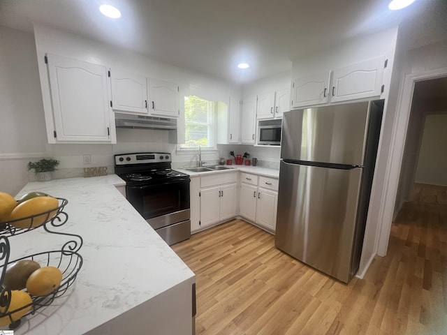 3023 Plainview Rd, Anderson, SC 29626 - kitchen with stainless steel appliances, under cabinet range hood, light wood-style flooring, white cabinets, and recessed lighting