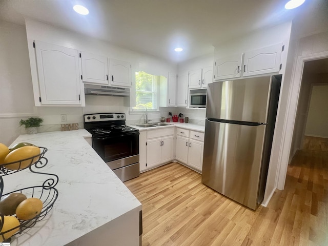 3023 Plainview Rd, Anderson, SC 29626 - kitchen with stainless steel appliances, under cabinet range hood, light wood-style floors, white cabinetry, and recessed lighting