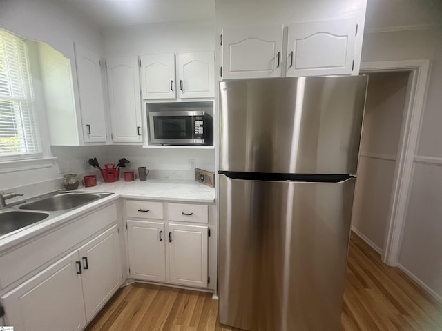 3023 Plainview Rd, Anderson, SC 29626 - kitchen with stainless steel appliances, light wood finished floors, white cabinets, and light countertops