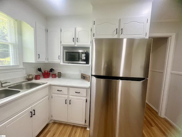 3023 Plainview Rd, Anderson, SC 29626 - kitchen featuring appliances with stainless steel finishes, light wood-style floors, white cabinets, and light countertops
