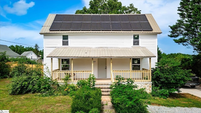 17 Smythe St, Pelzer, SC 29669 - view of front of home with a metal roof, covered porch, and roof mounted solar panels