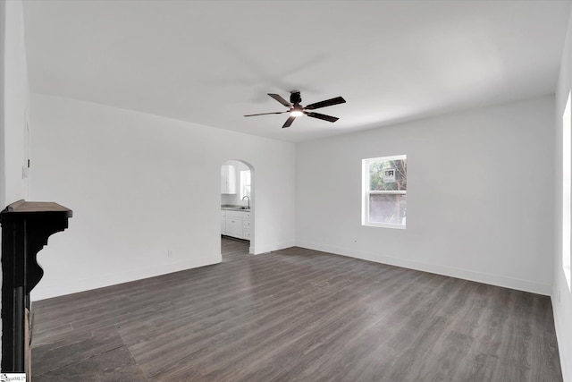 17 Smythe St, Pelzer, SC 29669 - unfurnished living room with arched walkways, a ceiling fan, and dark wood-style floors
