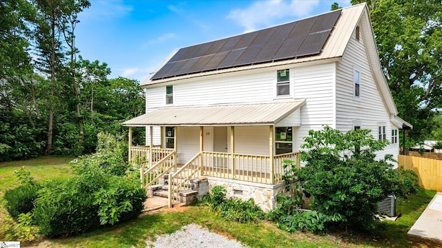 17 Smythe St, Pelzer, SC 29669 - view of front of house featuring a porch, a metal roof, and roof mounted solar panels