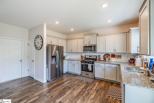 200 Bridlewood Ln, Piedmont, SC 29673 - kitchen featuring stainless steel appliances, dark wood-style flooring, decorative backsplash, light stone countertops, and recessed lighting