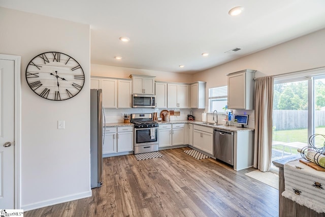 200 Bridlewood Ln, Piedmont, SC 29673 - kitchen featuring stainless steel appliances, plenty of natural light, light wood-type flooring, light stone counters, and recessed lighting