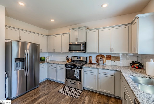 200 Bridlewood Ln, Piedmont, SC 29673 - kitchen featuring stainless steel appliances, dark wood finished floors, decorative backsplash, light stone countertops, and recessed lighting