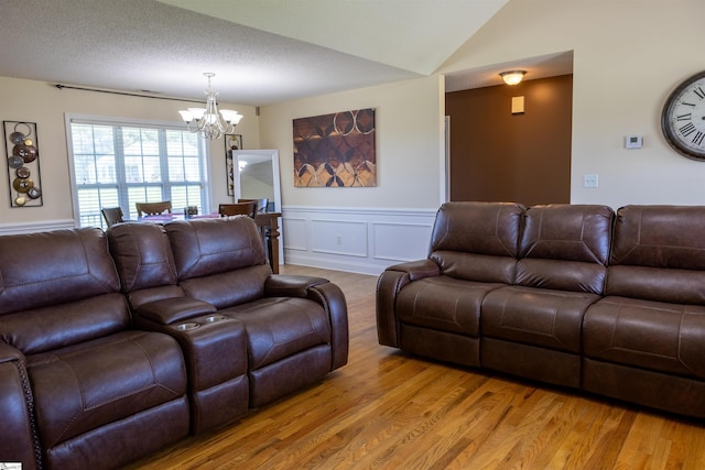 105 Hidden Springs Ct, Gaffney, SC 29341 - living area with a chandelier, light wood-type flooring, a wainscoted wall, a decorative wall, and vaulted ceiling