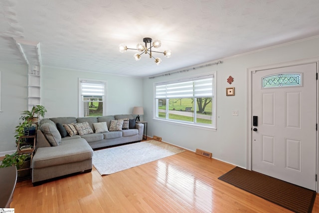 1142 Cooper Bridge Rd, Woodruff, SC 29388 - living area featuring wood finished floors, a chandelier, and a textured ceiling