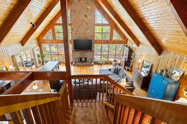 207 Sassafras Dr, Taylors, SC 29687 - living room with a wooden ceiling with exposed beams, a fireplace, wood finished floors, high vaulted ceiling, and wooden walls