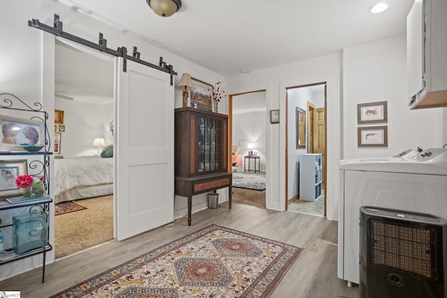 207 Sassafras Dr, Taylors, SC 29687 - interior space featuring washer / dryer, a barn door, and light wood-style flooring