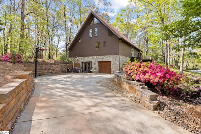 207 Sassafras Dr, Taylors, SC 29687 - view of side of property with stone siding, driveway, and a garage