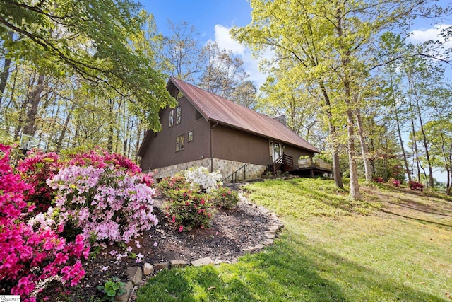 207 Sassafras Dr, Taylors, SC 29687 - view of home's exterior with stone siding, a lawn, a deck, and a metal roof