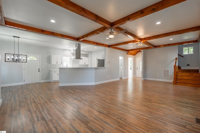 5 Mcgee St, Belton, SC 29627 - unfurnished living room featuring wood finished floors, beam ceiling, recessed lighting, a chandelier, and stairs
