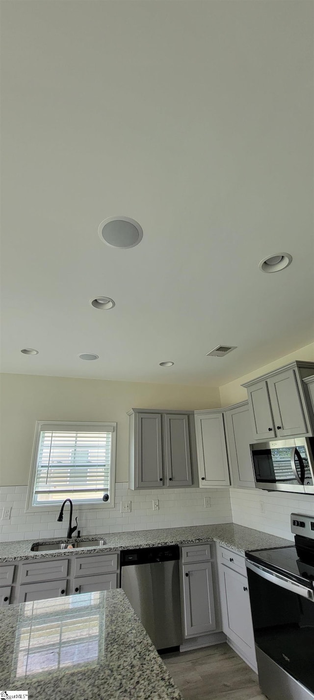 638 Grantleigh Dr, Duncan, SC 29334 - kitchen with appliances with stainless steel finishes, backsplash, light stone counters, and recessed lighting