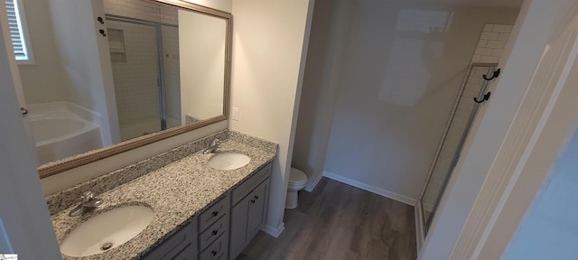 638 Grantleigh Dr, Duncan, SC 29334 - bathroom featuring a stall shower, double vanity, a bath, and wood finished floors