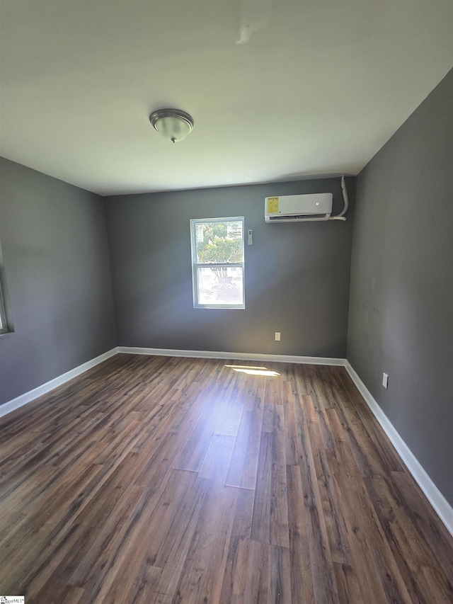 207 Sanders St, Honea Path, SC 29654 - spare room featuring a wall unit AC and dark wood finished floors