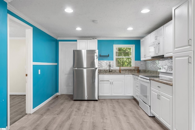 209 Edwards Rd, Lyman, SC 29365 - kitchen with white appliances, light wood-style floors, ornamental molding, white cabinetry, and decorative backsplash