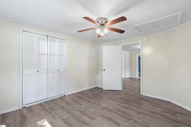 209 Edwards Rd, Lyman, SC 29365 - unfurnished bedroom with wood finished floors, crown molding, a closet, attic access, and a ceiling fan