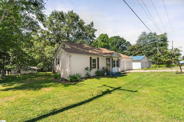 209 Edwards Rd, Lyman, SC 29365 - back of house featuring concrete driveway, a lawn, and view of wooded area