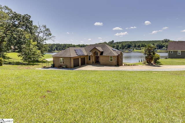450 Johnson Ave, Anderson, SC 29621 - view of front of home with roof mounted solar panels, a water view, concrete driveway, a garage, and brick siding