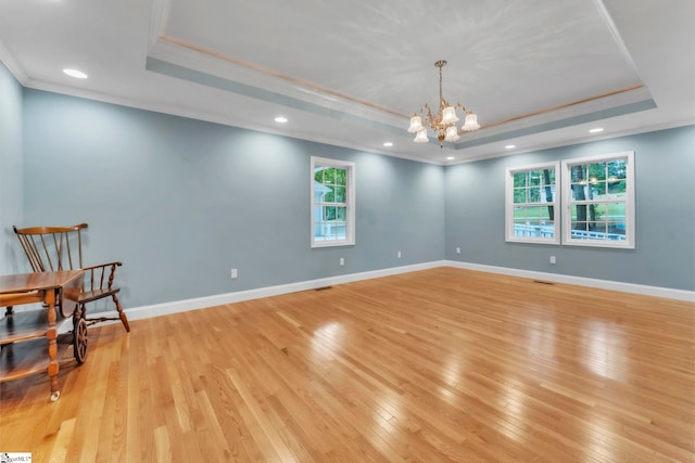 1 Moultrie Dr, Taylors, SC 29687 - unfurnished room featuring a raised ceiling, crown molding, light wood-style floors, a chandelier, and recessed lighting