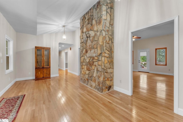 1 Moultrie Dr, Taylors, SC 29687 - unfurnished living room with light wood-style flooring, a towering ceiling, and a ceiling fan