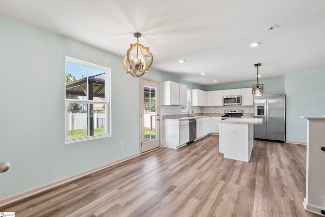 166 Bleckley Trl, Anderson, SC 29625 - kitchen with stainless steel appliances, light wood-style floors, light countertops, a chandelier, and tasteful backsplash