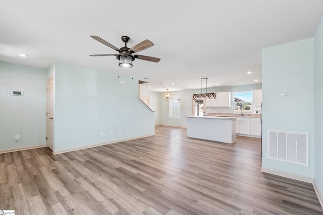 166 Bleckley Trl, Anderson, SC 29625 - unfurnished living room with light wood-style floors, recessed lighting, ceiling fan, and a chandelier