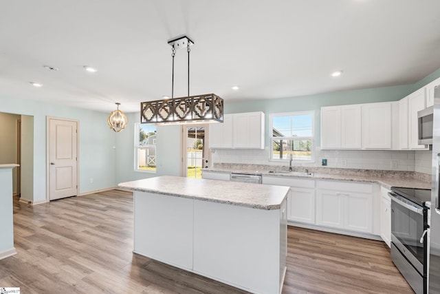 166 Bleckley Trl, Anderson, SC 29625 - kitchen featuring stainless steel appliances, tasteful backsplash, a chandelier, white cabinetry, and a center island